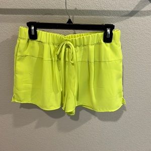 Neon green elastic waist shorts with pockets